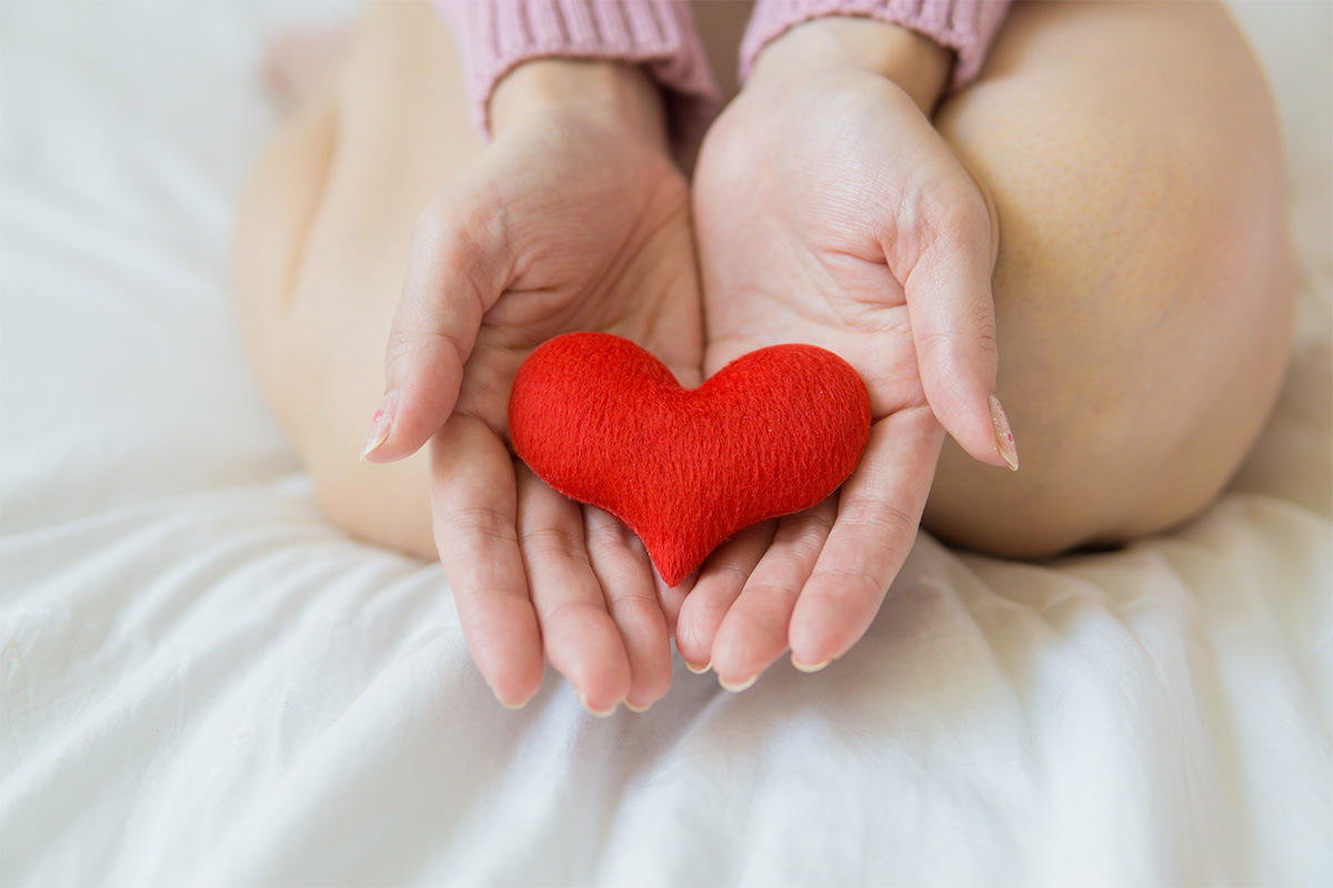 hands holding a plushie heart
