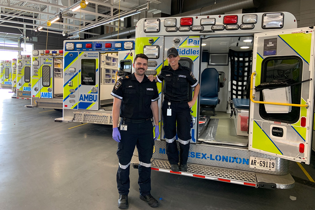 Two paramedics in front of an ambulance