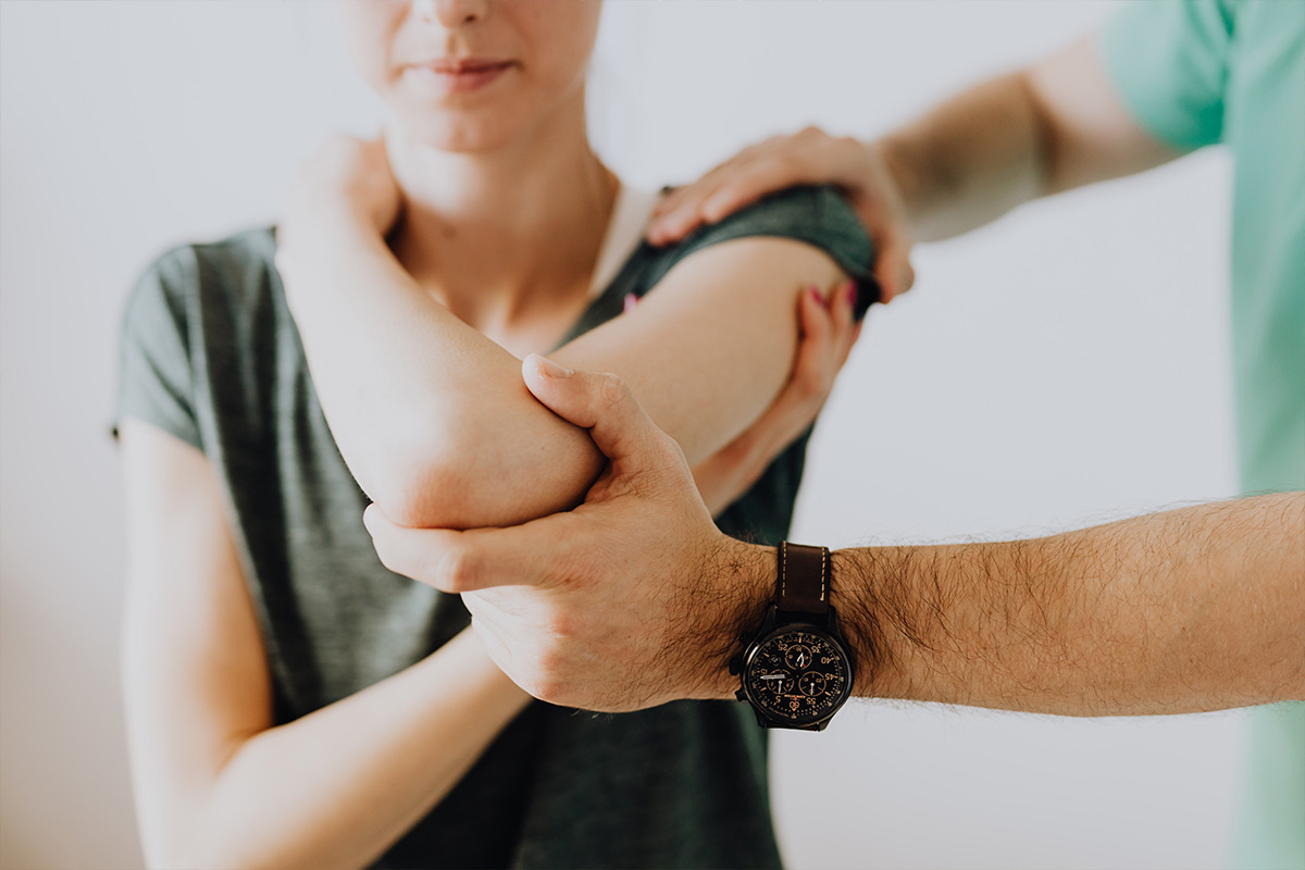 person holding elbow