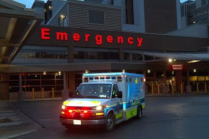 Ambulance parked outside base with lights on
